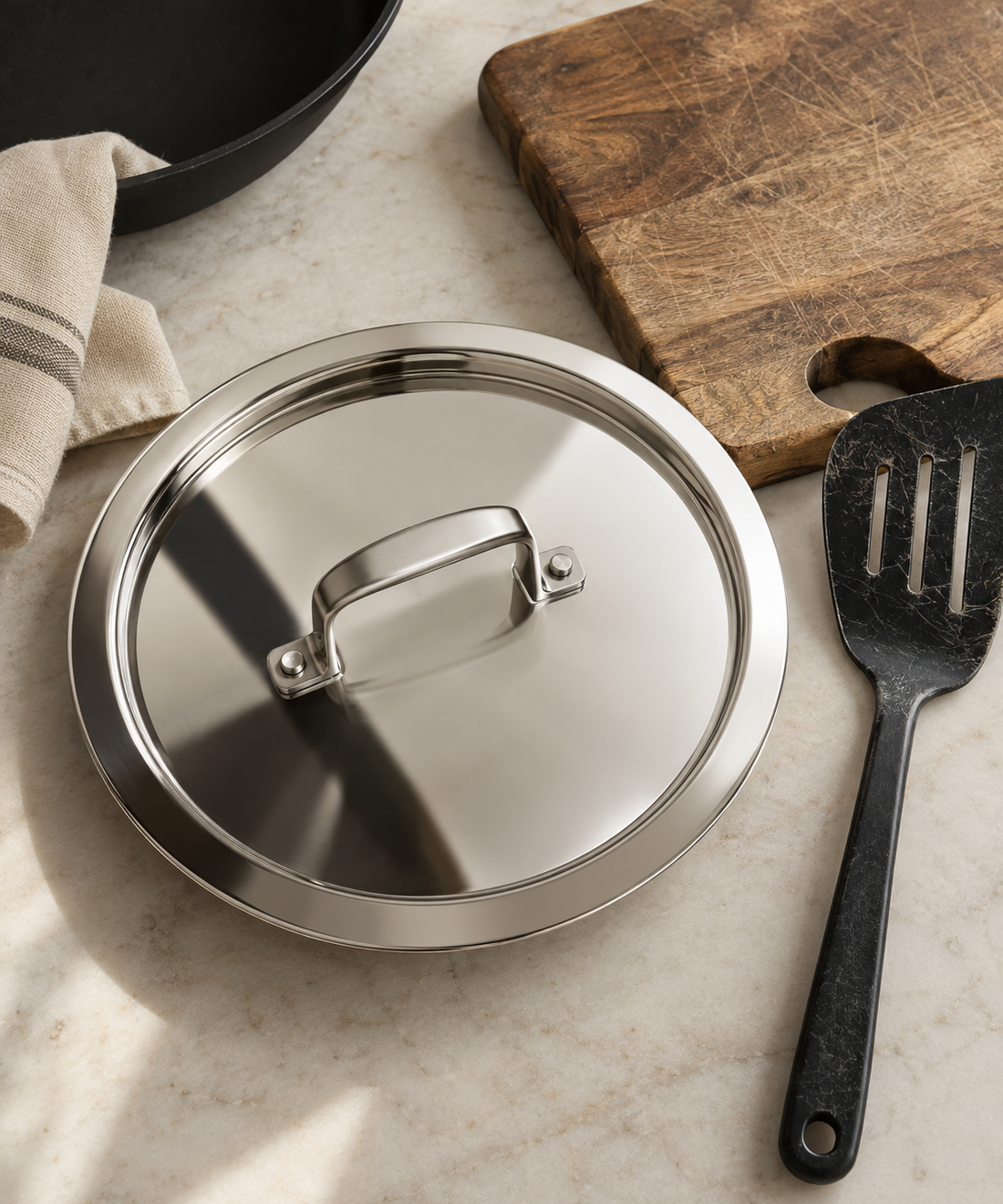 Stainless steel pan lid next to a wooden board and plastic utensil, comparing kitchen hygiene